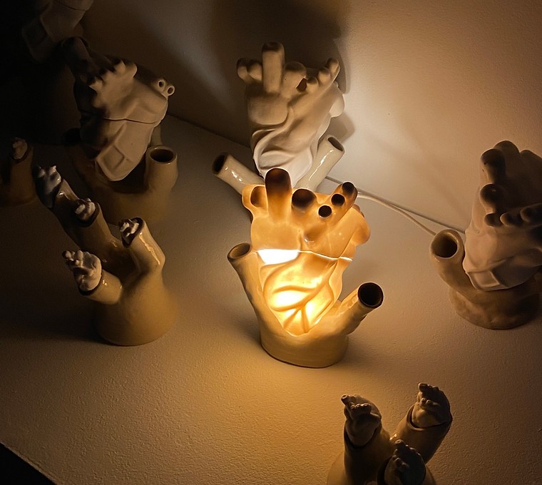 Individual view of a unique ceramic heart from Perfect Imperfection series by Yuxin Song. Highlighting cracks with cubic zirconia and mica powder. Light-up sculpture made with resin, 2022.