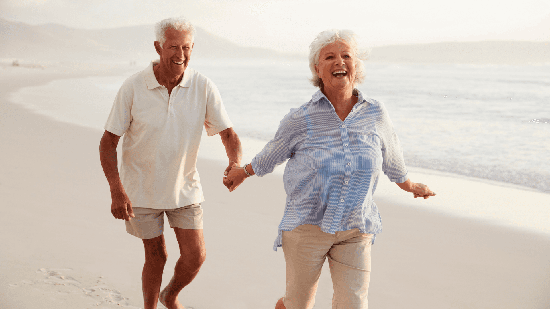 Young woman with shoulder-length dark hair wearing a pink collared shirt, looking directly at camera
