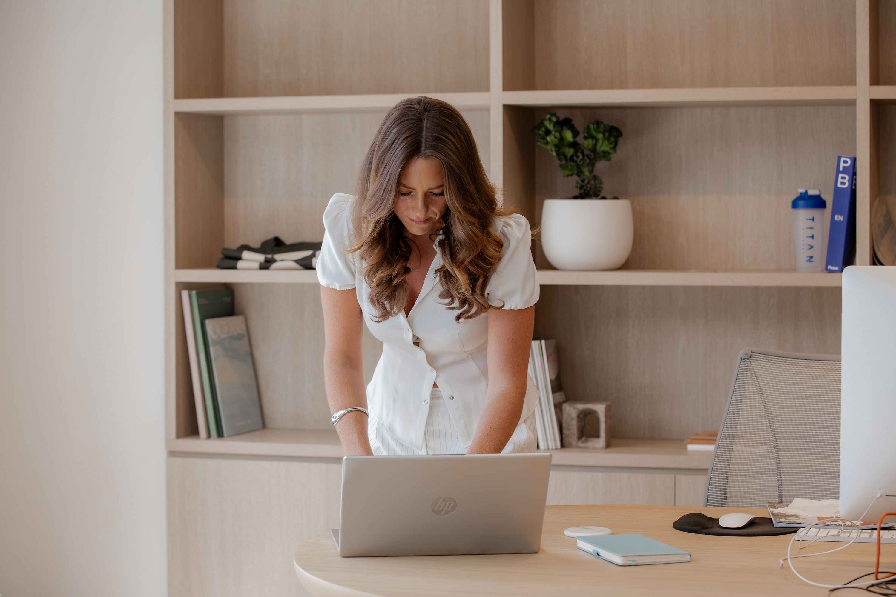 Smiling woman using a laptop.