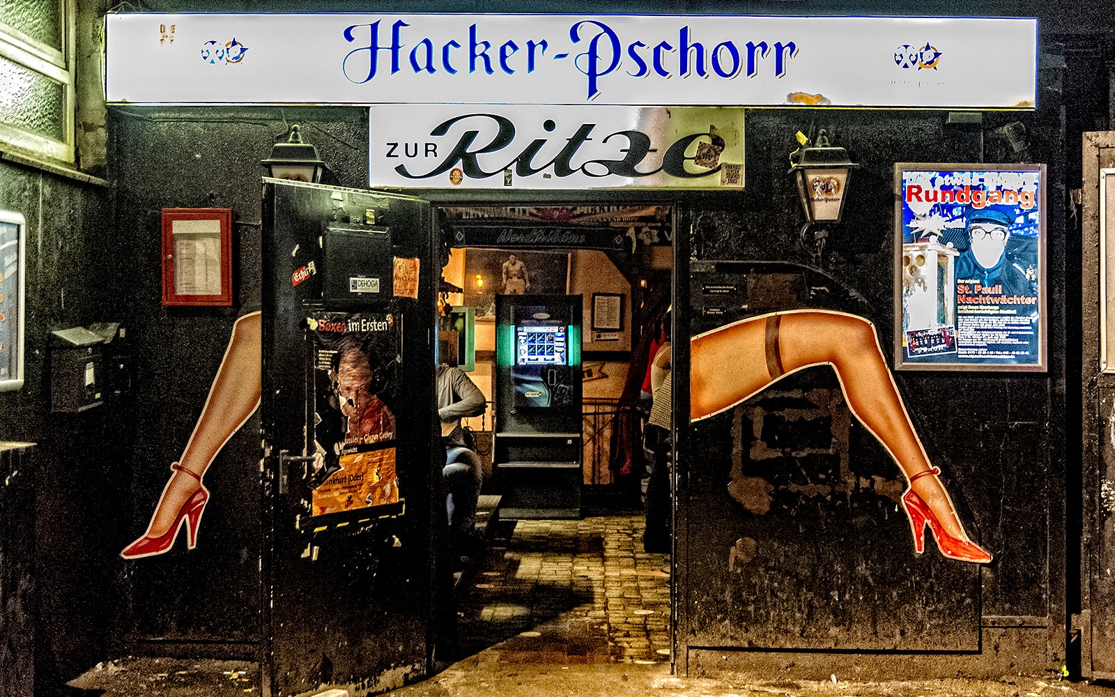 Entrance to Zur Ritze bar in St. Pauli, Hamburg, featuring iconic leg artwork.