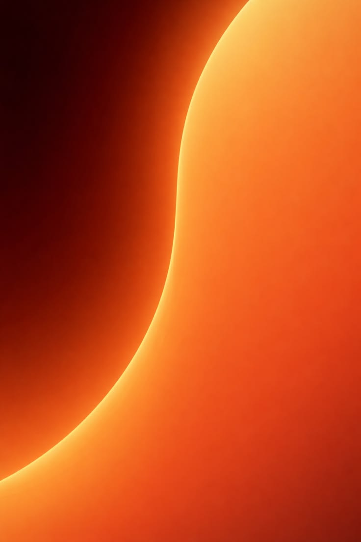 Abstract image featuring a smooth gradient from dark red to orange, with a flowing curved line. The warm tones evoke a sense of calm and warmth.