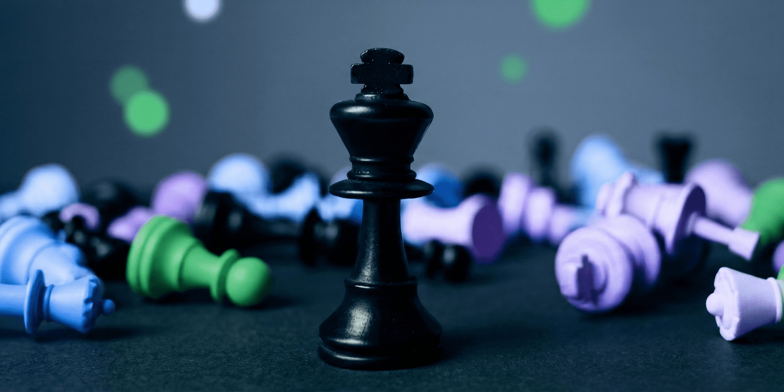 Aerial view of a winding road cutting through rocky terrain and sandy landscape.