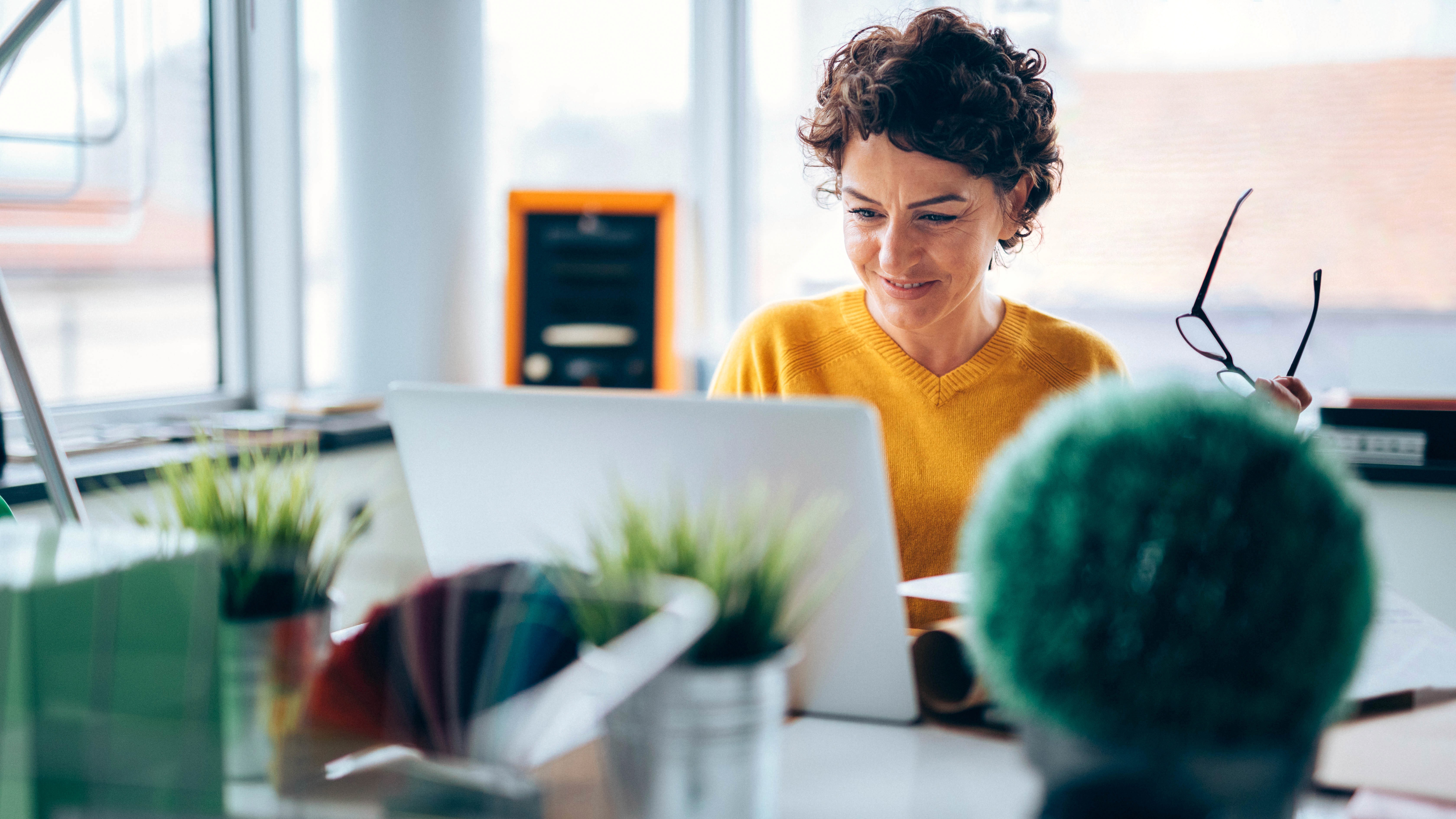 Woman working in ticketing looking at laptop