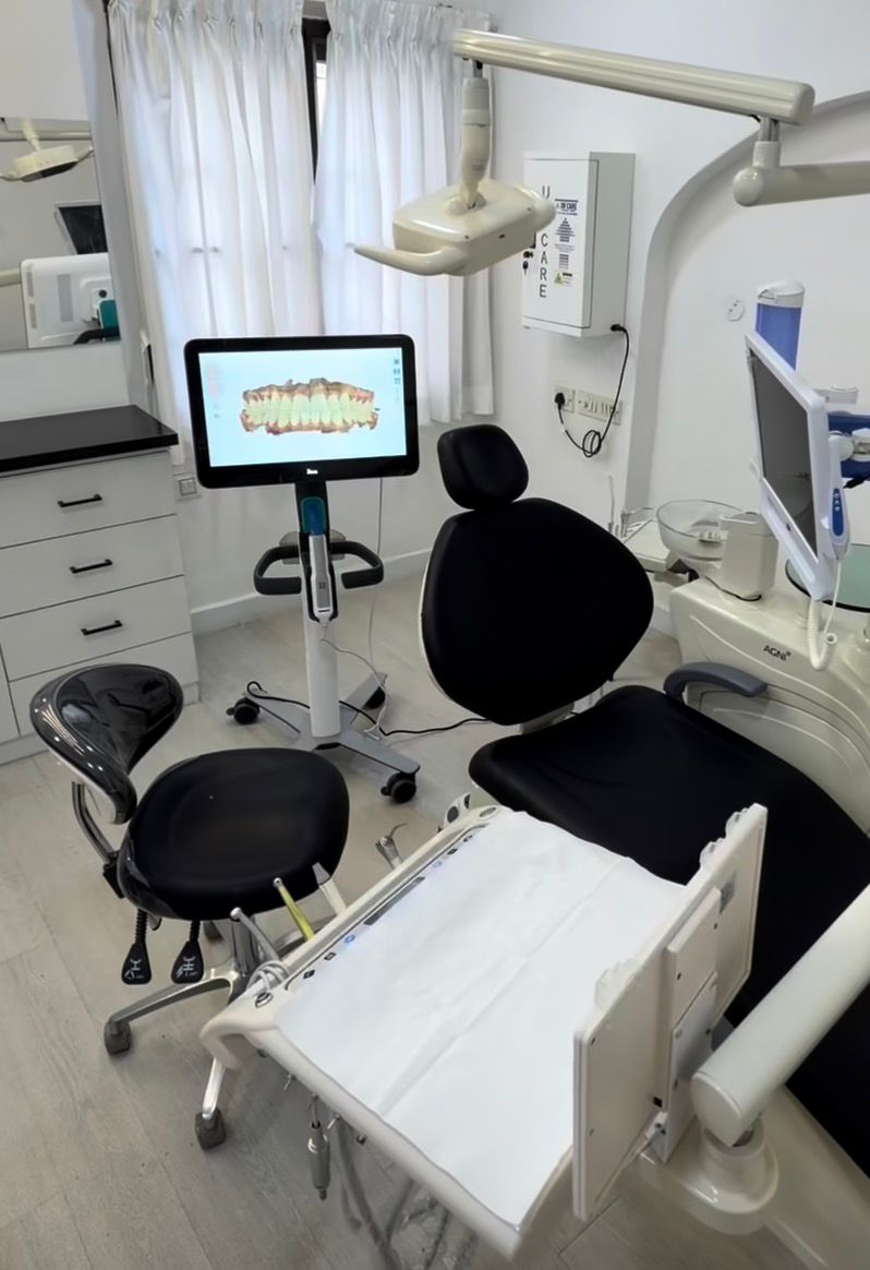 Close-up of dental check-up with gloved hands using mirror to inspect patient’s teeth and gums