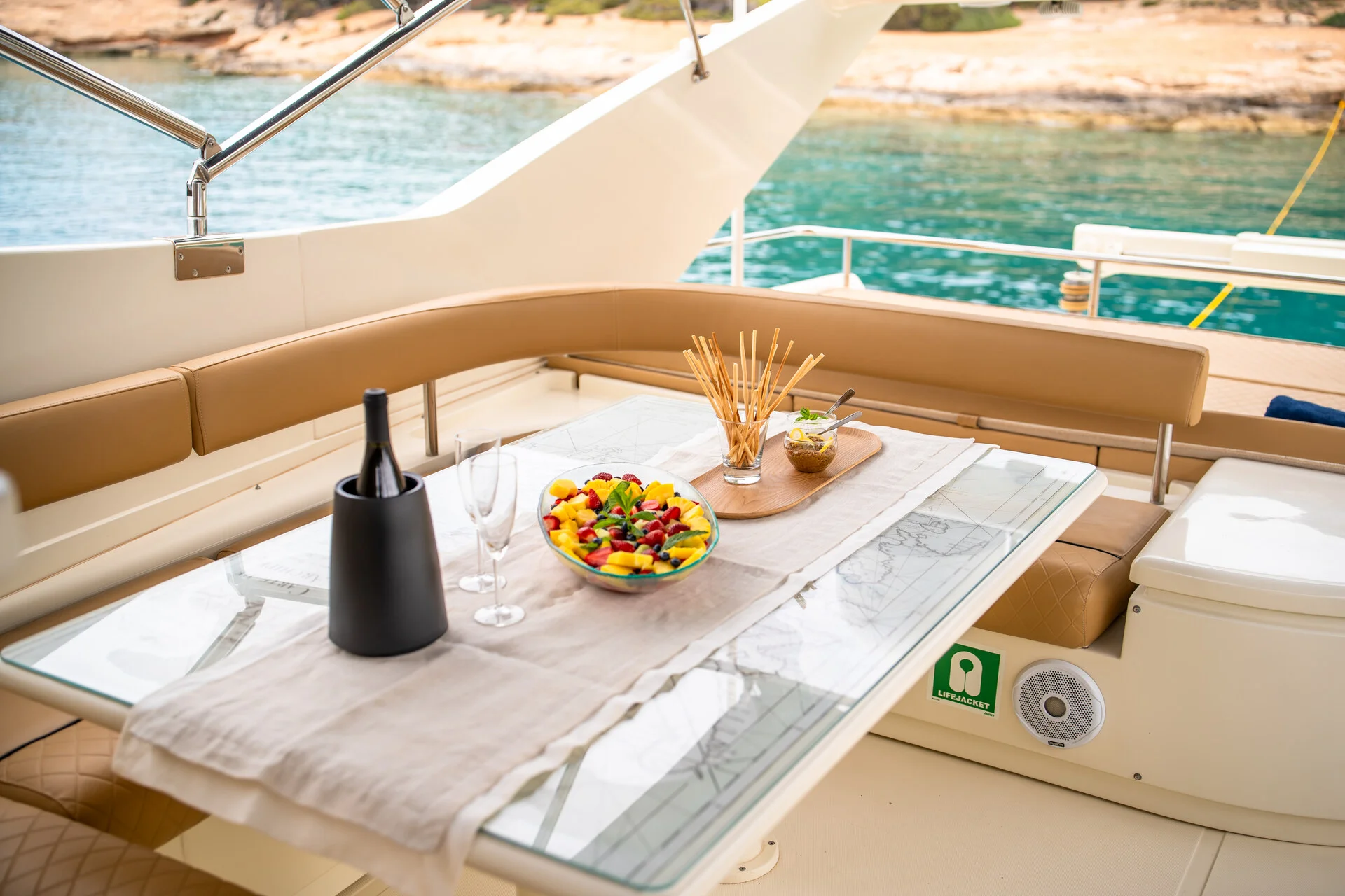 White Rock 36 speedboat with captain at helm cruising calm blue waters near Paros coastline with hills in background.