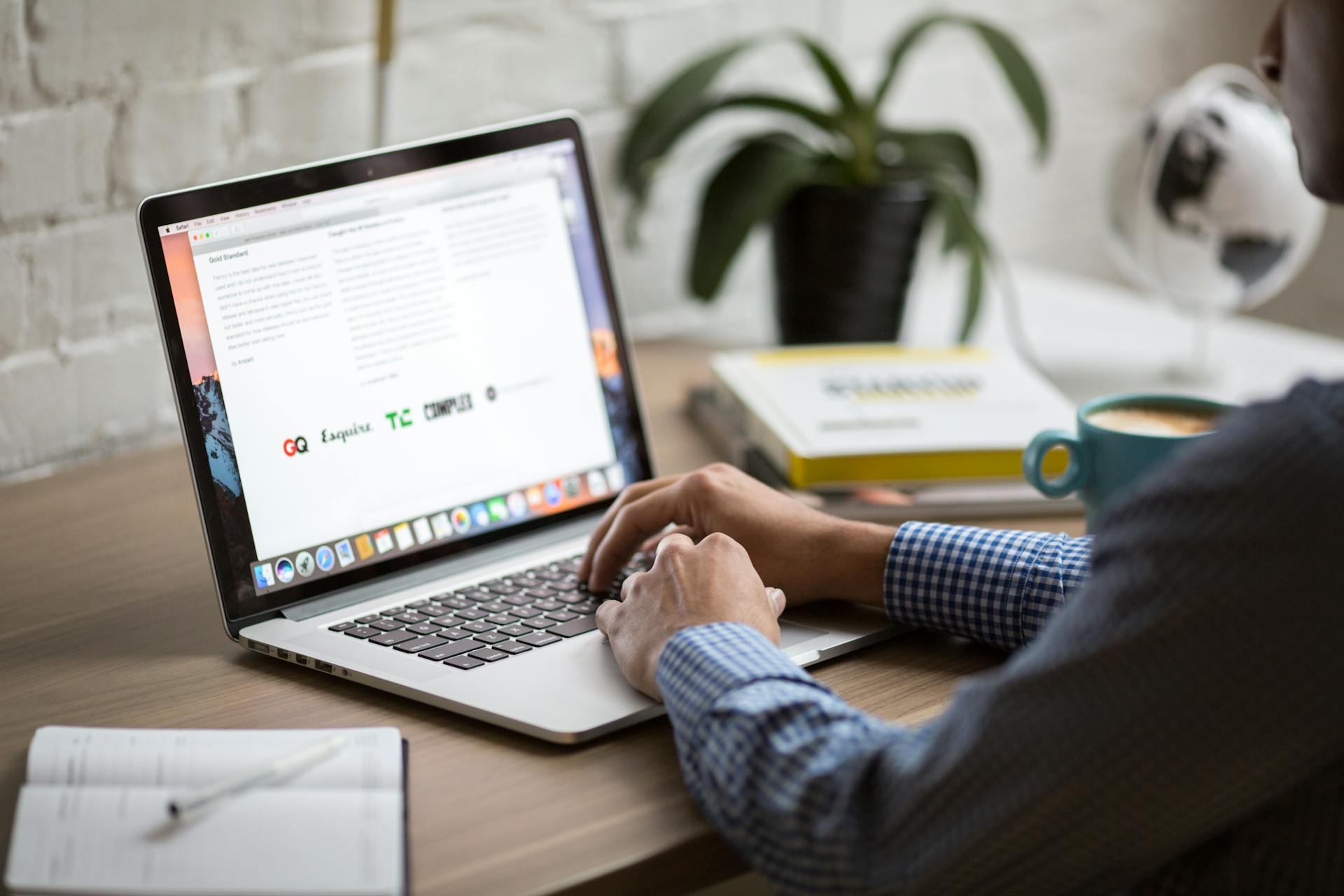 Man concentrating while typing on a silver laptop