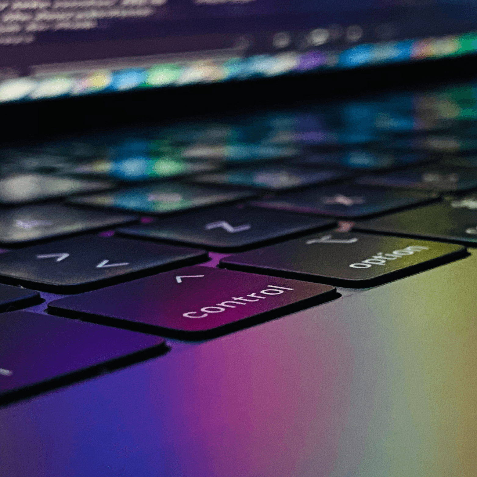 Macbook keyboard with the screen glowing onto the keys