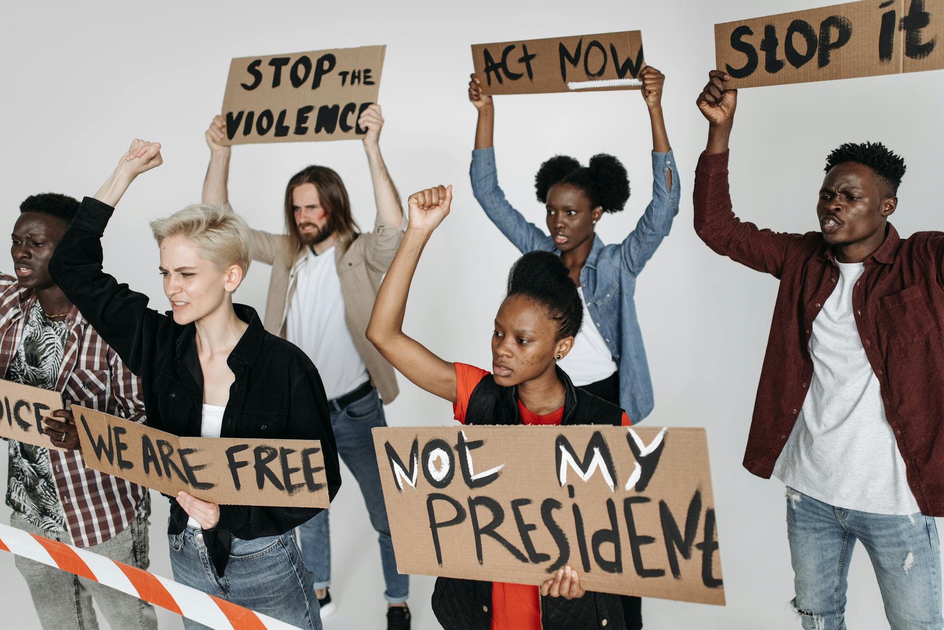 Two architects in hard hats examining the exterior of a modern white building with large windows