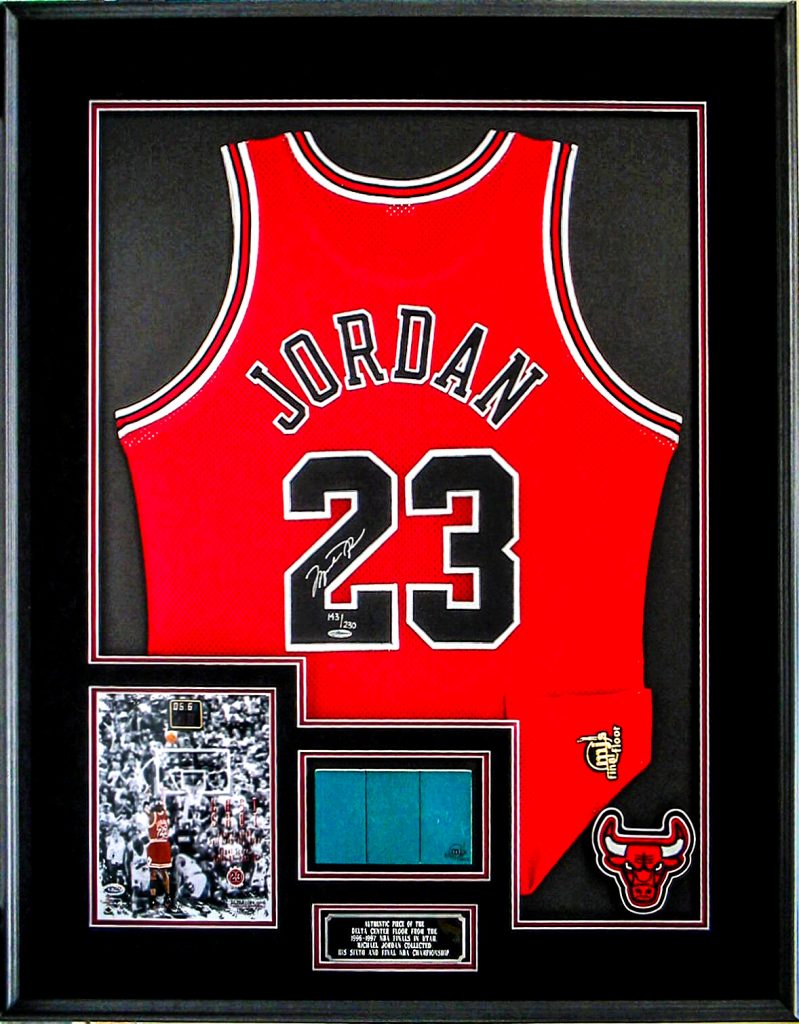 Modern kitchen with a wooden dining table, white chairs, and a hanging light fixture above.