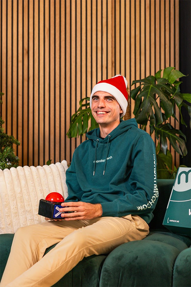 Monday Merch employee with christmas hat and monday merch sweater