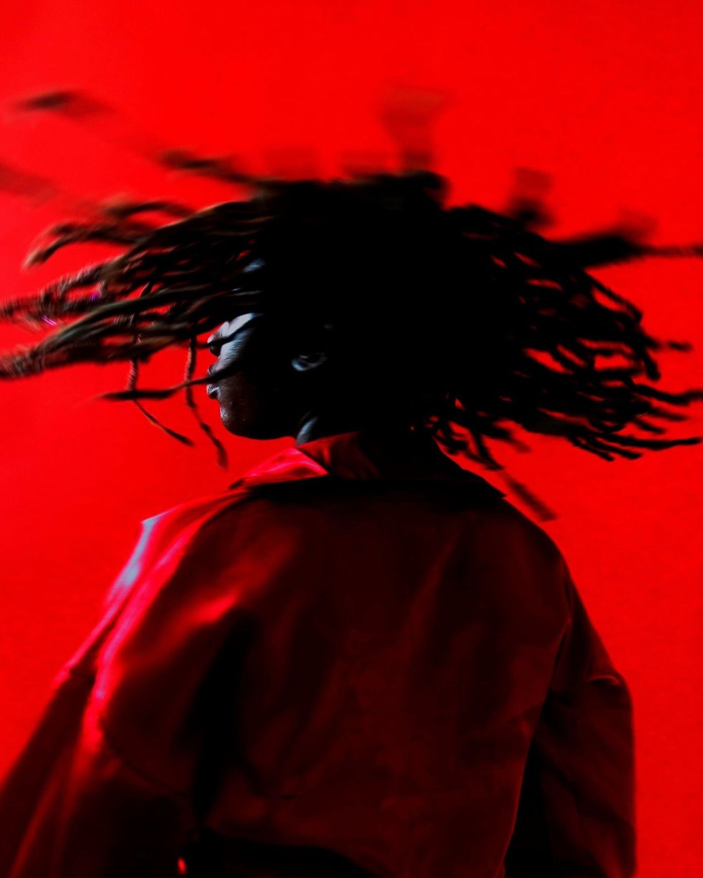 Woman with red hair covering mouth with hair