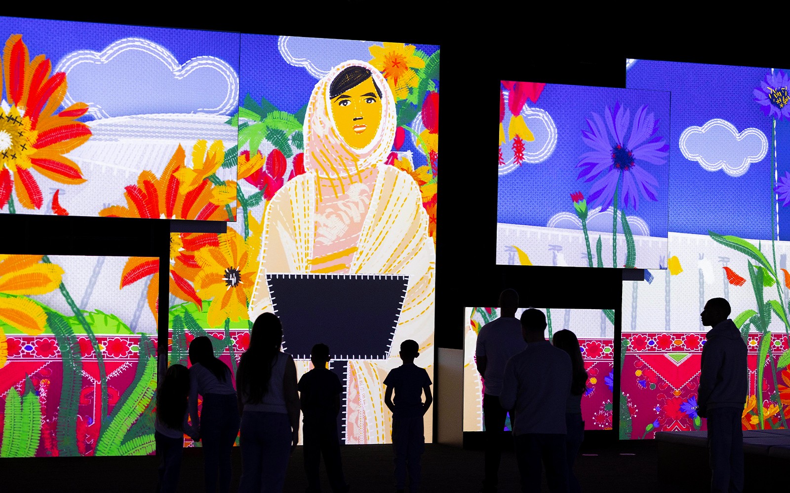 Visitors viewing vibrant digital art at Frameless National Portrait Gallery Exhibition.