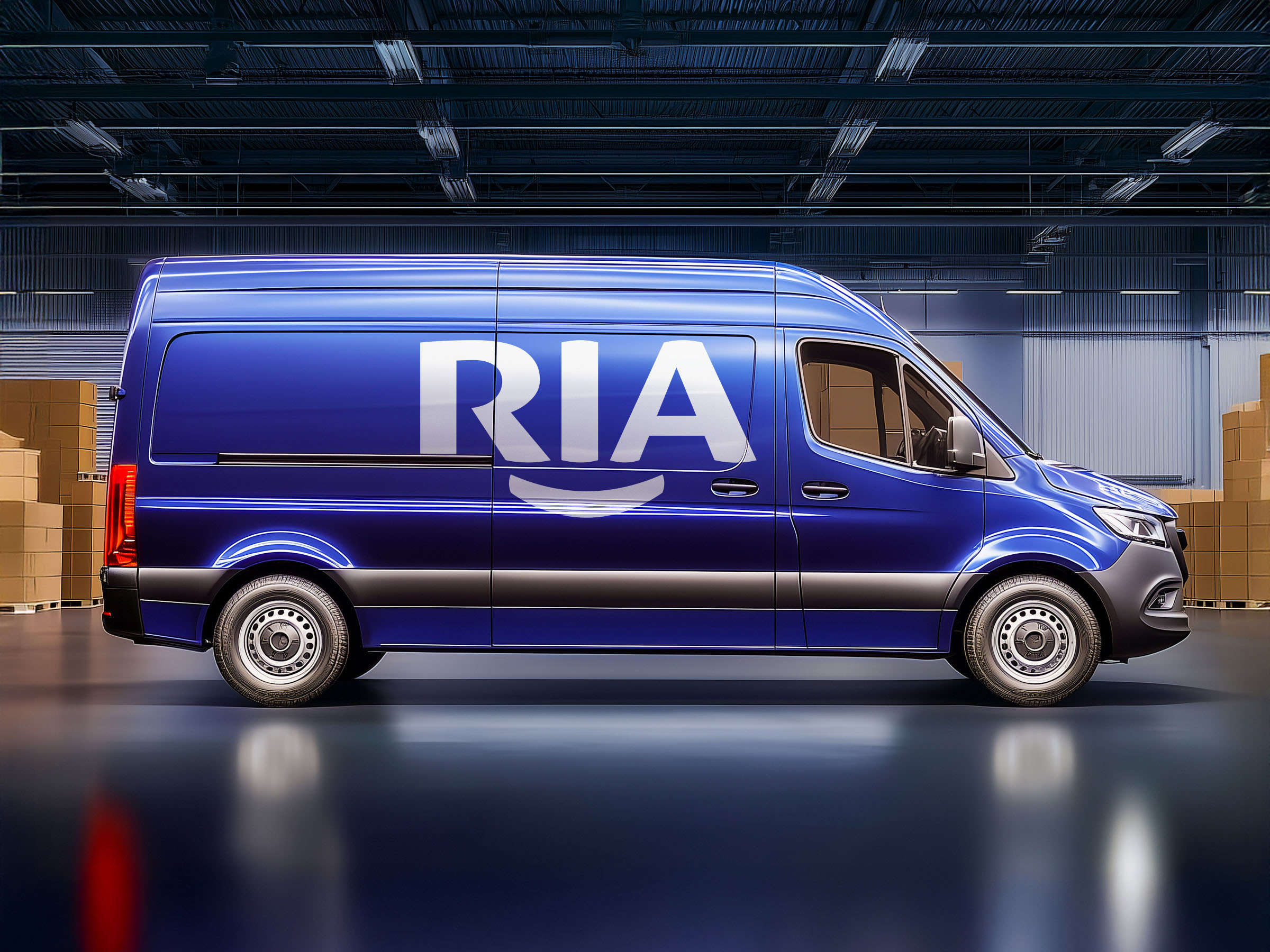 RIA logo applied across a blue delivery van inside a modern warehouse.