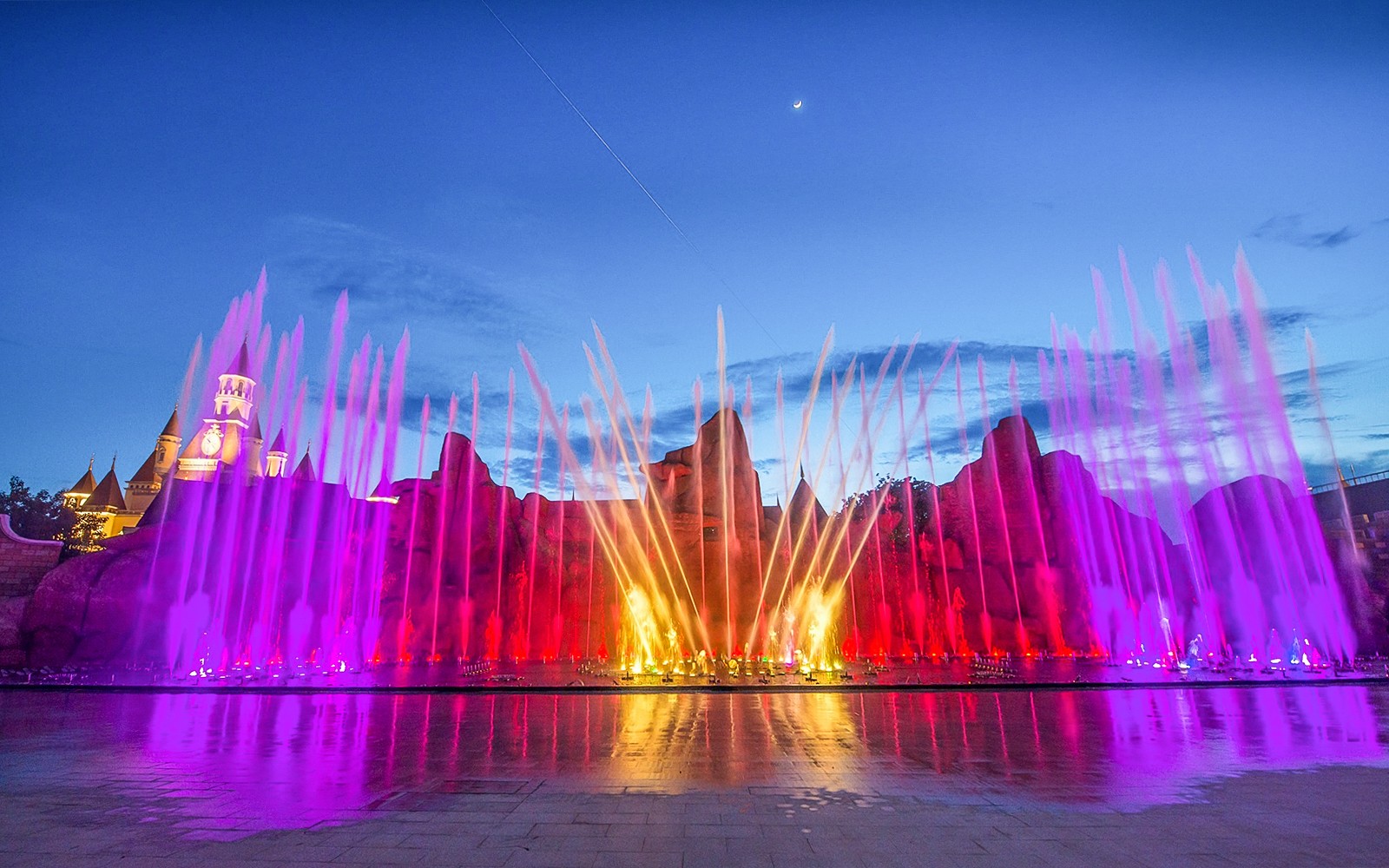 VinWonders Nha Trang colorful fountain show at night with castle backdrop.