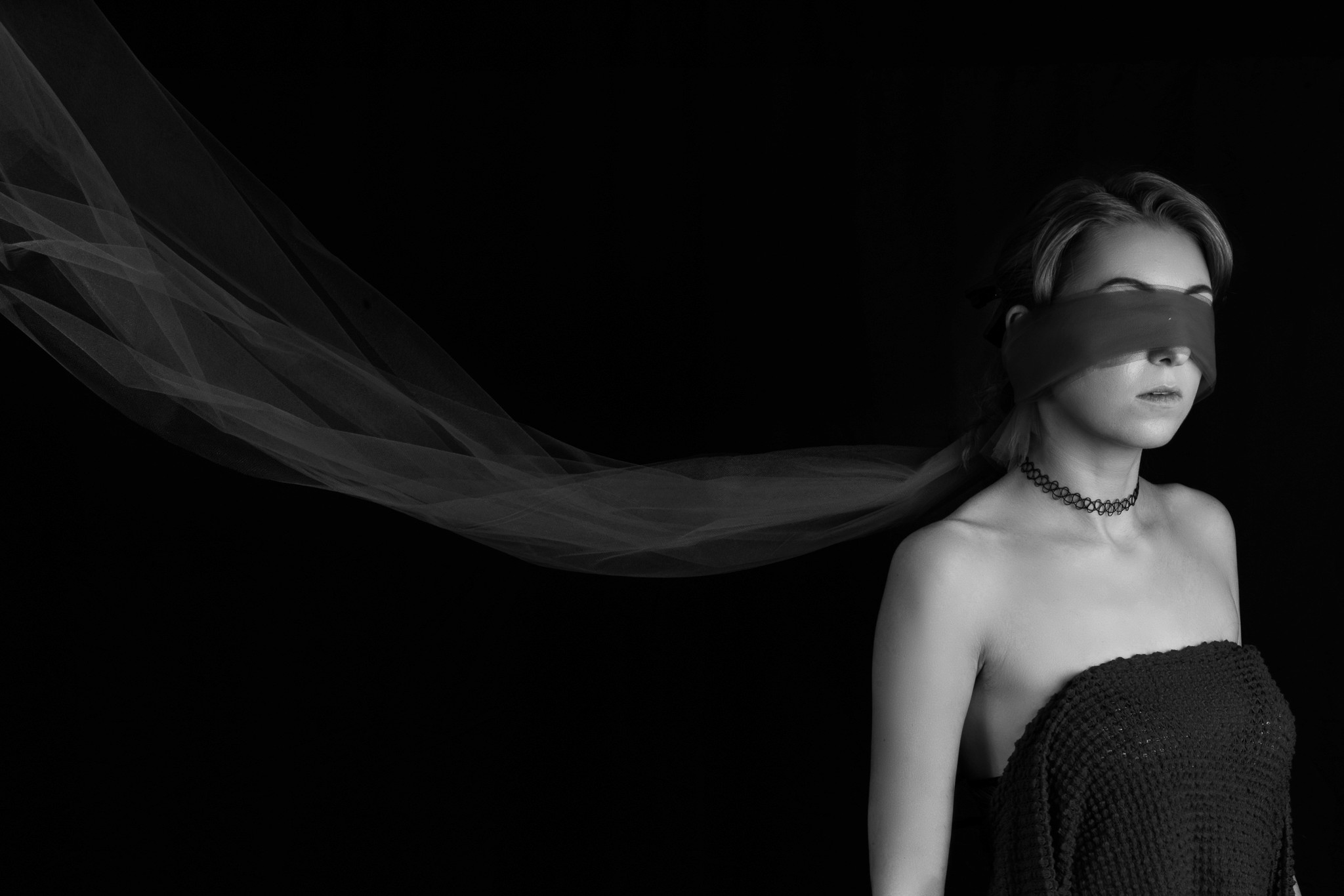 A still body of water with mountains in the background at sunset