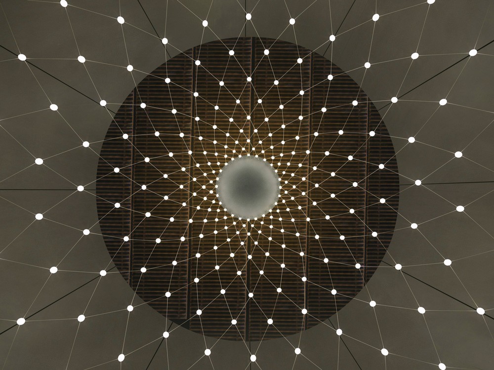 Installation process of the bespoke lighting feature at the Botswana Innovation Hub, displaying the assembly of the steel cable net and LED nodes.