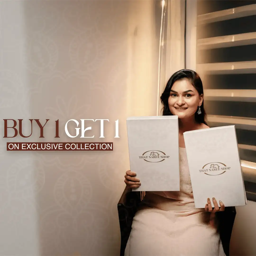 Two women wearing elegant sarees from That Saree Shop—one in pink and one in blue—standing gracefully on the grand royal staircase of a luxurious mansion.