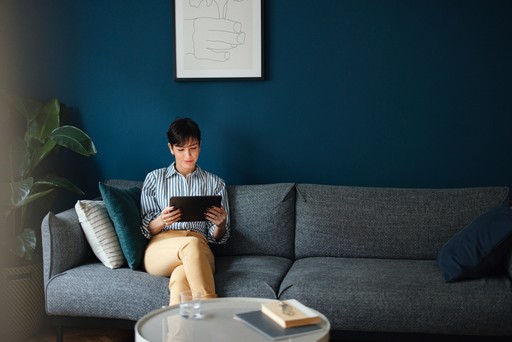 woman consulting a tablet on a sofa