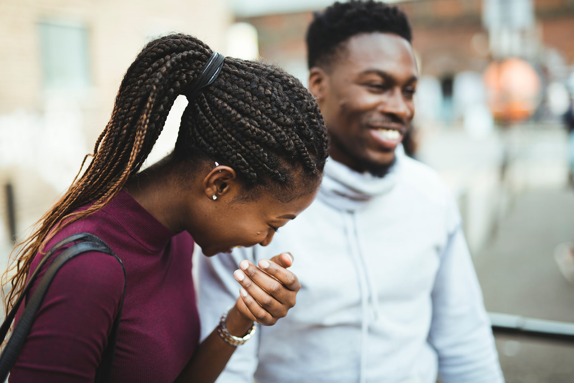 Two people laughing together outdoors, symbolising hope after homelessness