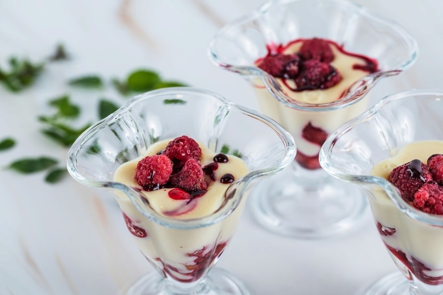 Layered dessert cups with raspberries and cream