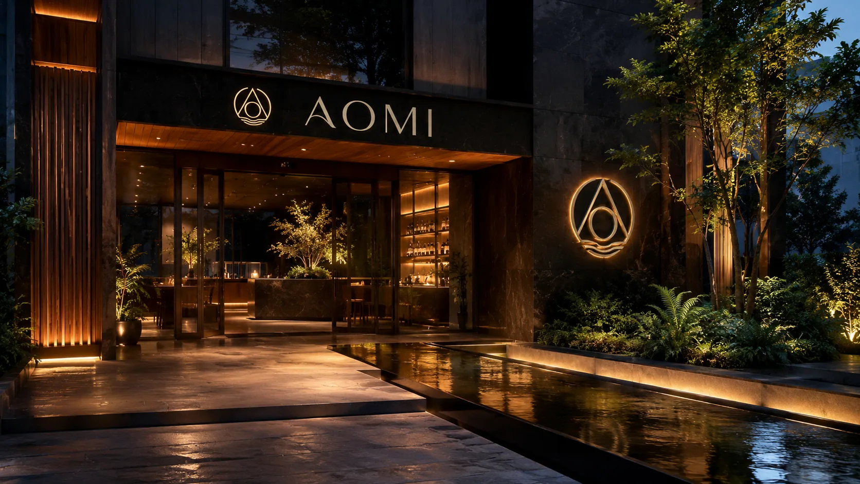 AOMI urban tea house entrance at dusk — illuminated signage, warm-lit glass facade and a reflecting water path framed by greenery