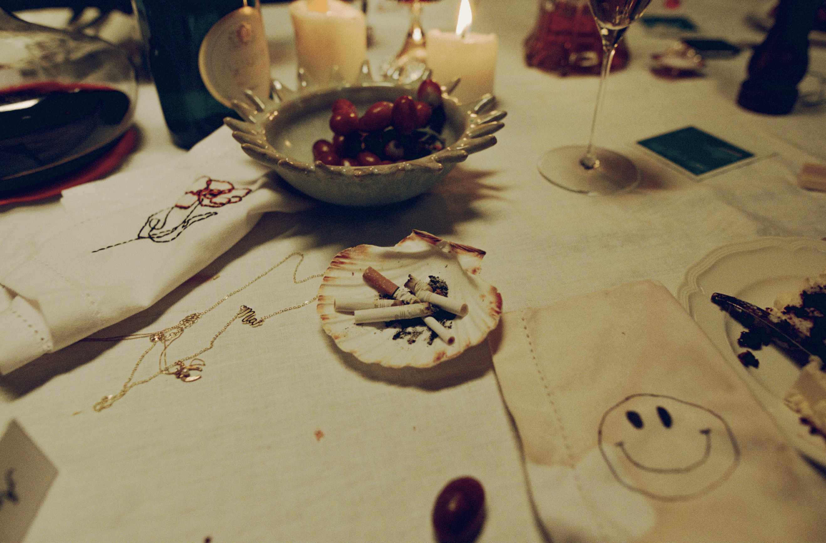 A decorative floral arrangement spills over a table draped in red fabric, creating an elegant atmosphere.