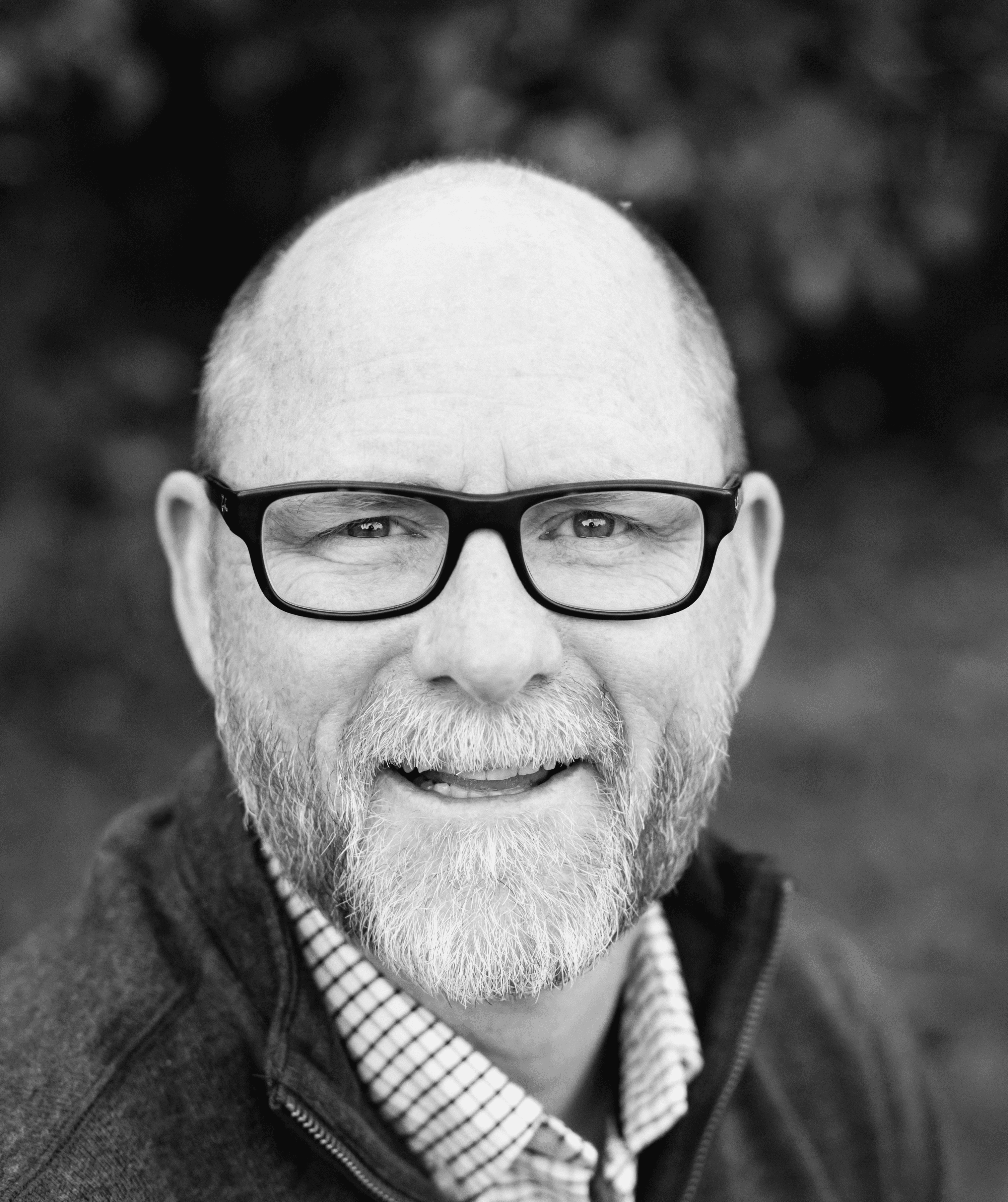 grayscale of man wearing eyeglasses