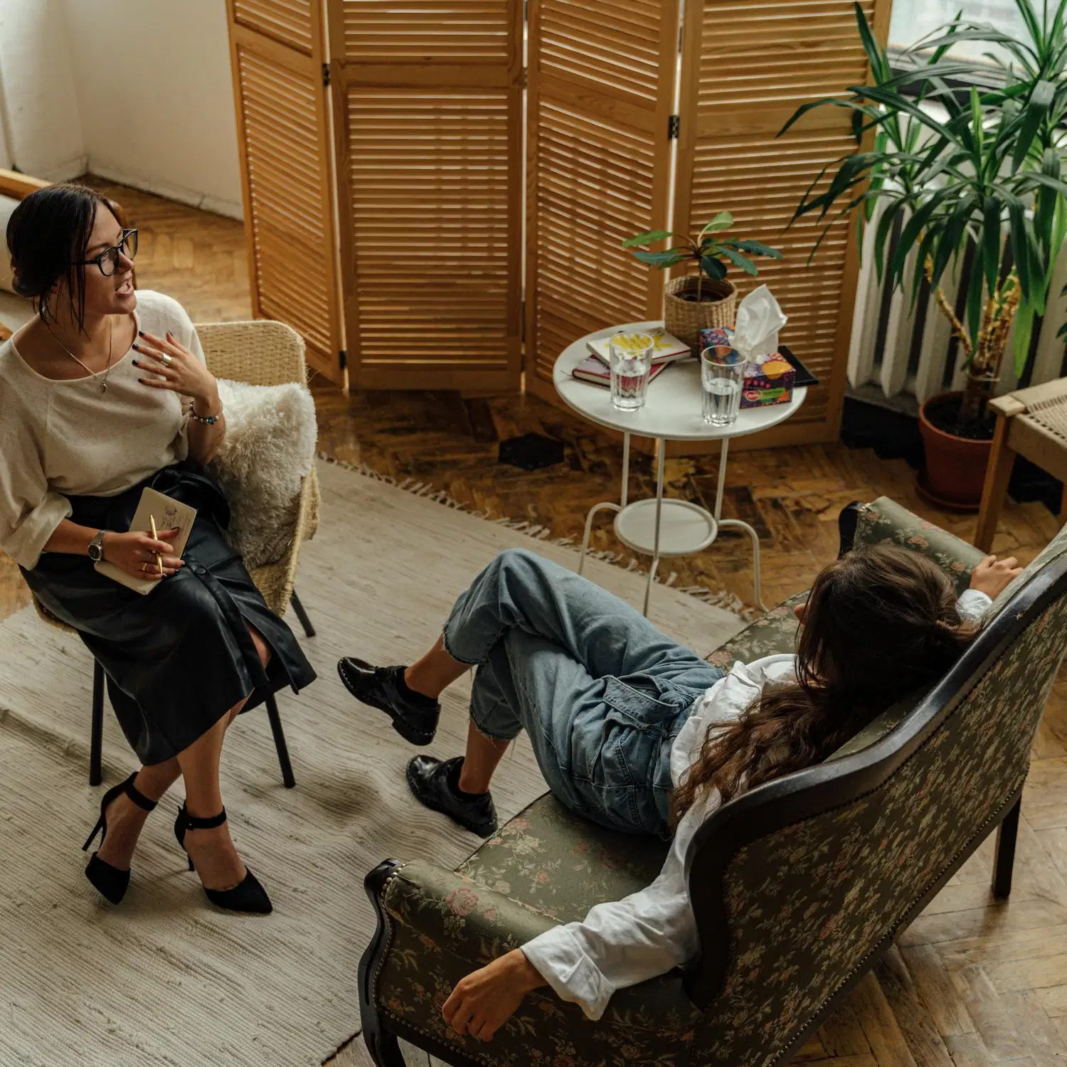 Therapist and client in a relaxed counseling session discussing gender exploration therapy and identity support in Los Angeles.
