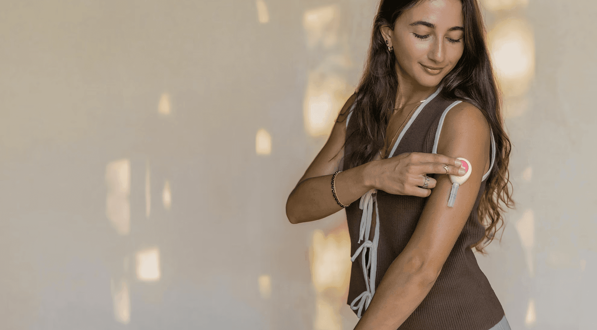 Woman collecting a blood sample from his upper arm using an at-home test kit.