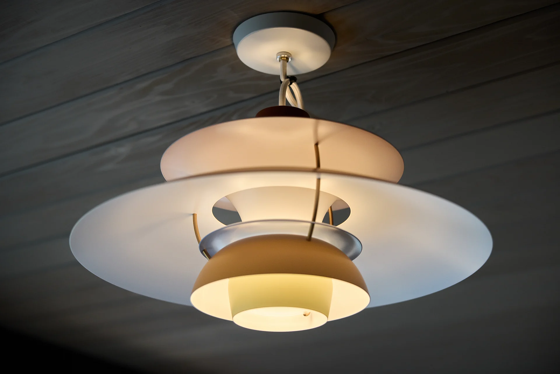 Close-up of the midcentury modern pendant light in the dining room, exemplifying the blend of classic style and contemporary design in the Fairhills Eichler Tract home. Photo by Todd Huge.