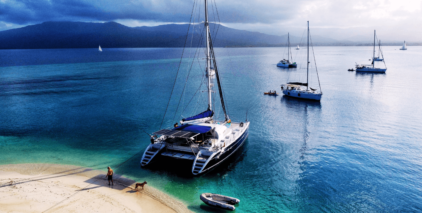 A beautiful "arrival" shot. The Nomade seen from the air waiting in the turquoise water. The "prize" at the end of the journey