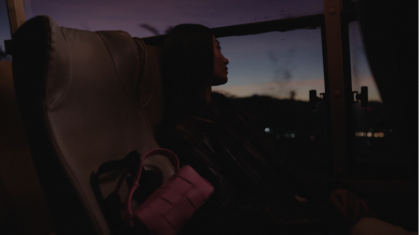 Two fathers carrying children on shoulders on a mountain path.