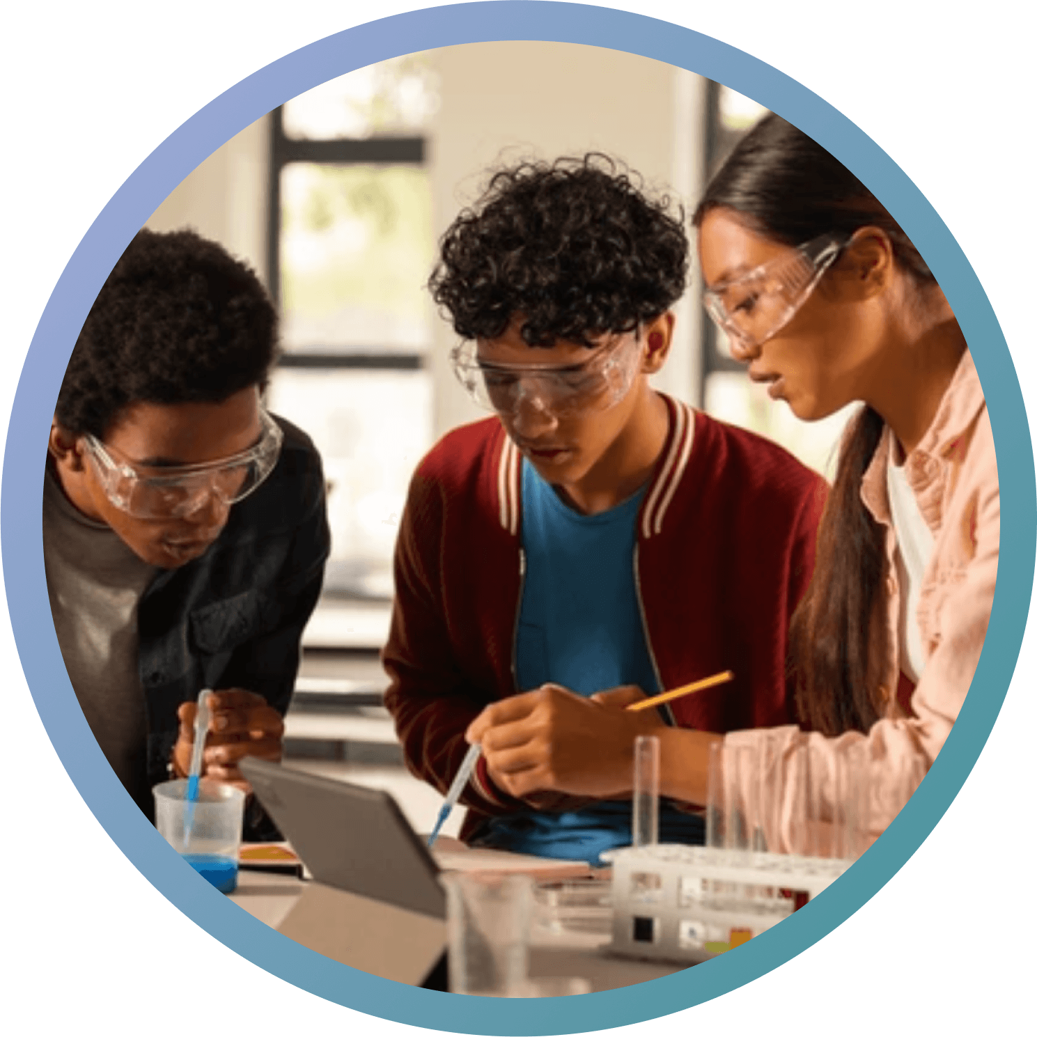 A group of young high school students studying on their laptops