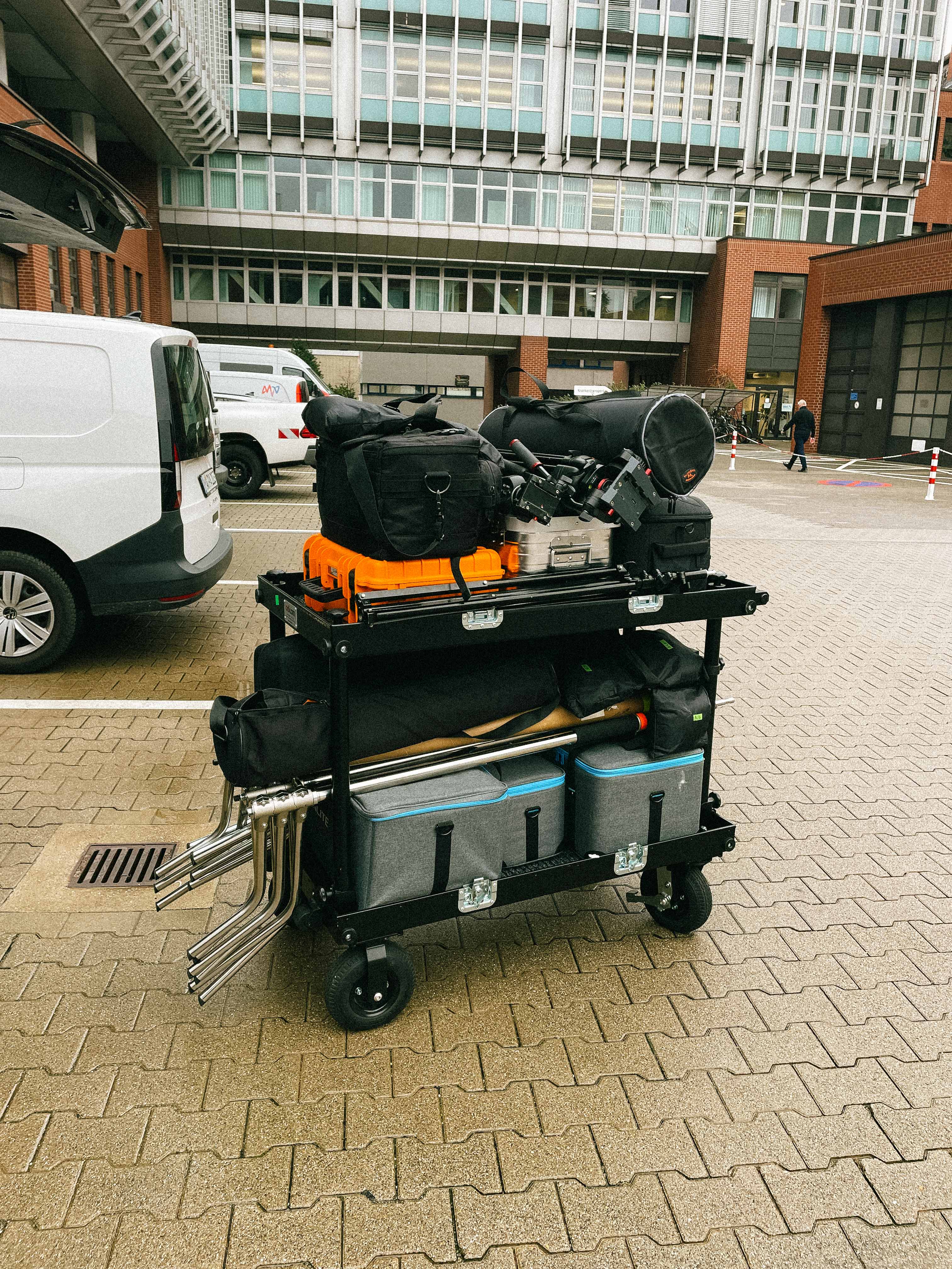 People playing soccer on a rooftop court surrounded by city buildings