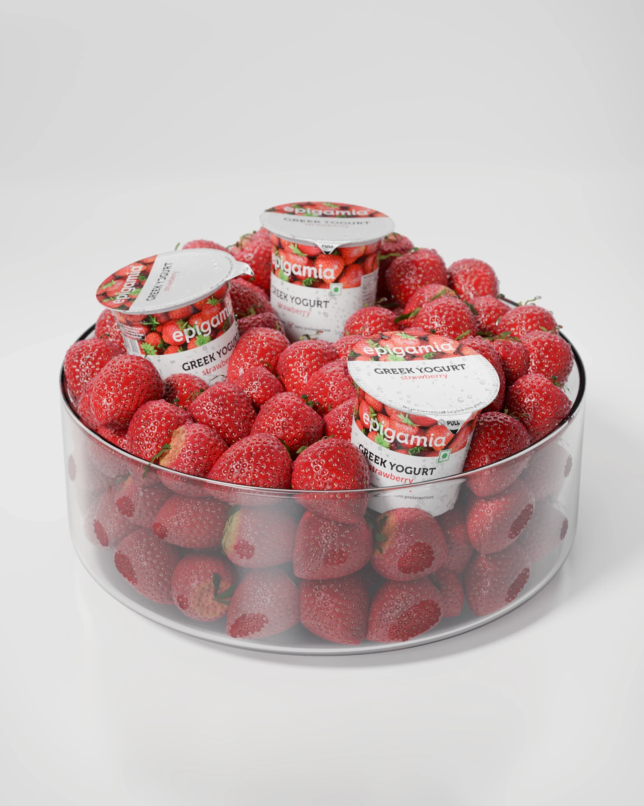 Epigamia Greek yogurt cups arranged in a bowl with strawberries