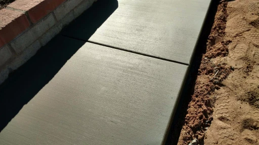 Smooth-finished concrete flatwork with brick border in Tucson