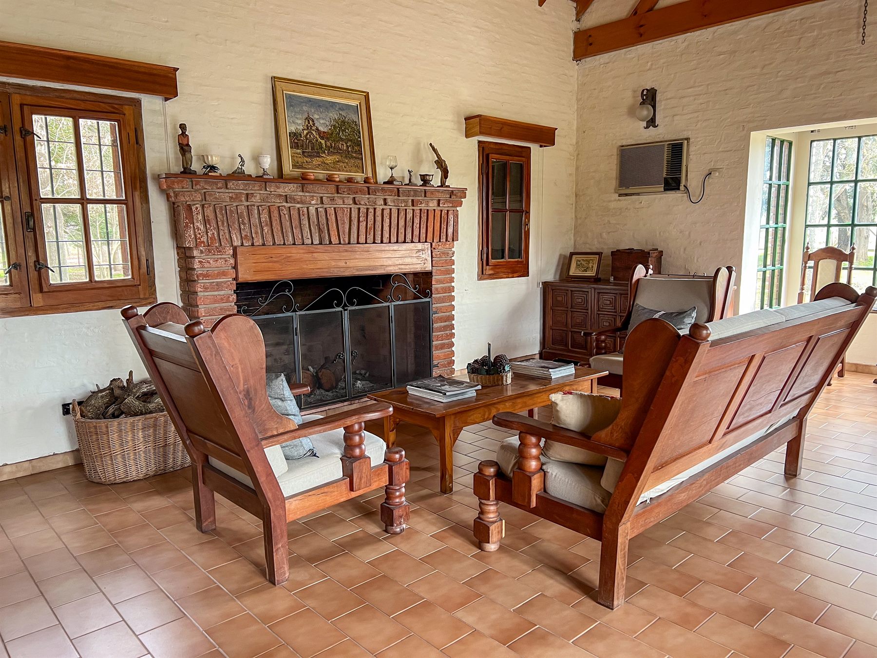 El living de la casona con la chimenea de ladrillo