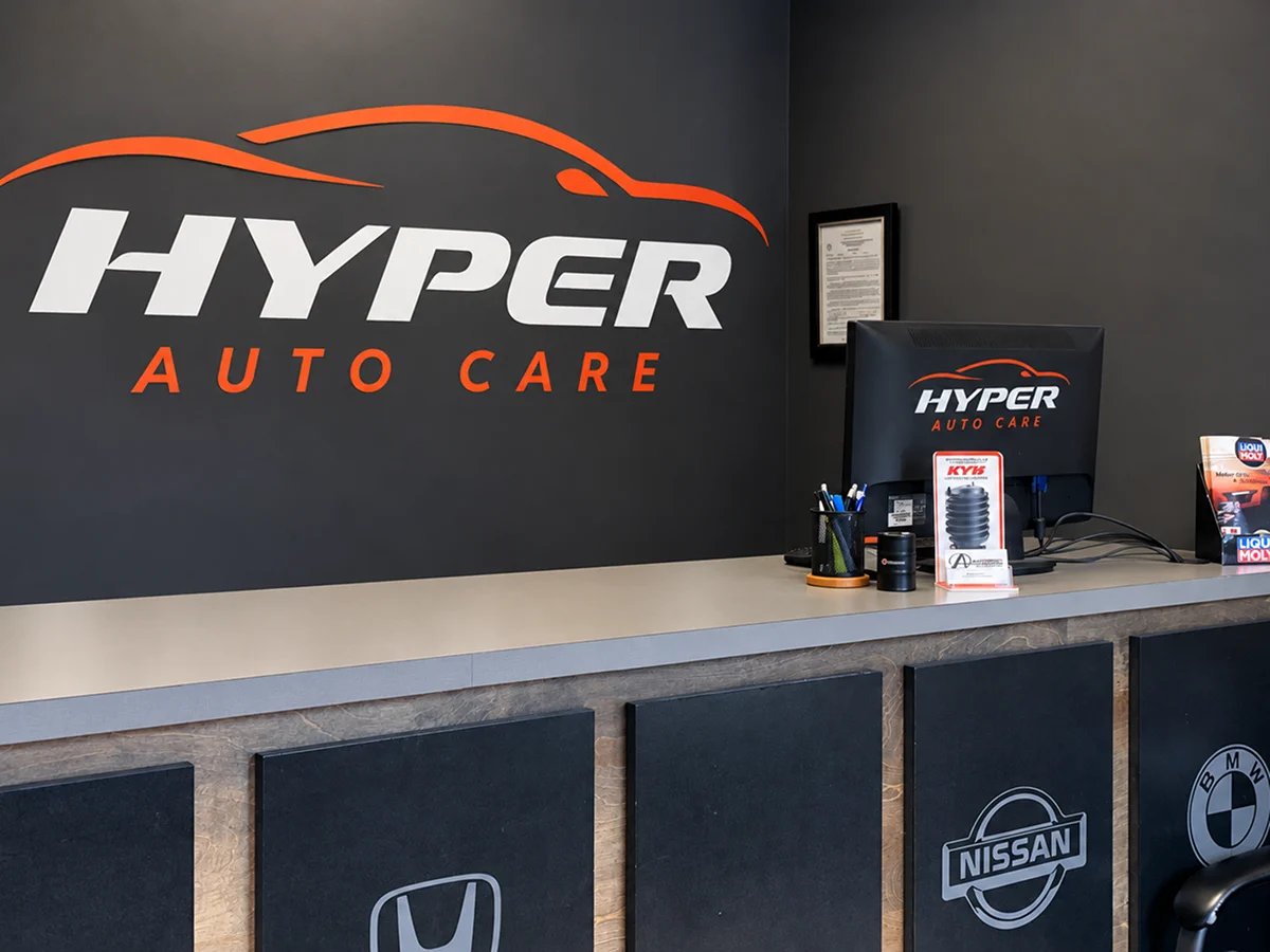HyperAuto Care reception counter with branded wall sign