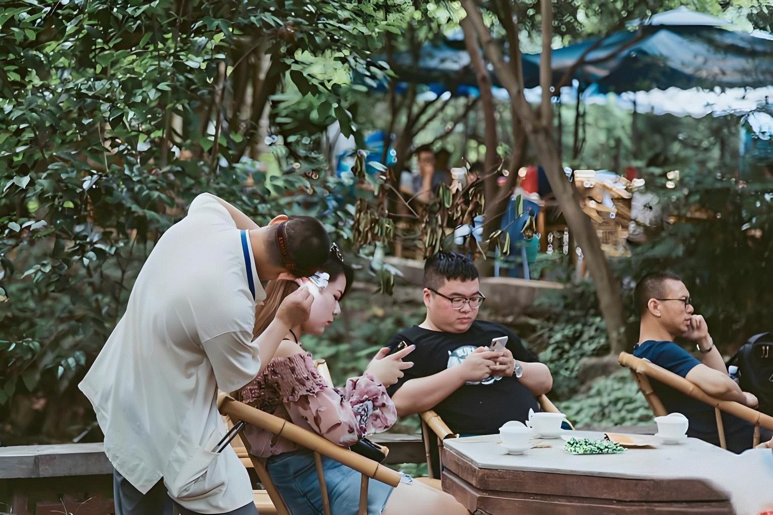Locals drinking jasmine tea at a traditional outdoor tea house in Chengdu