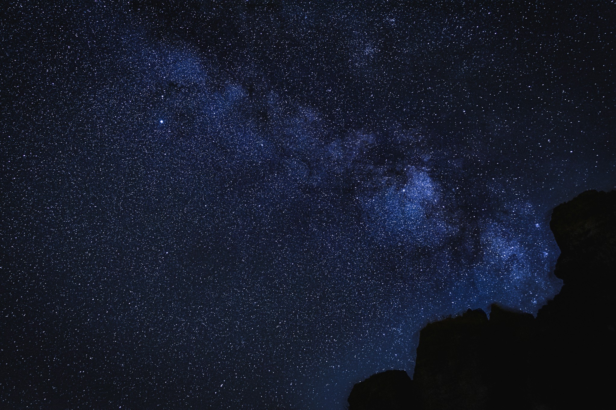 Elf woman in white dress raising hands by the river