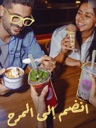 Group of friends savor ice cream and drinks, happily enjoying frozen yogurt with friends in a cheerful setting.