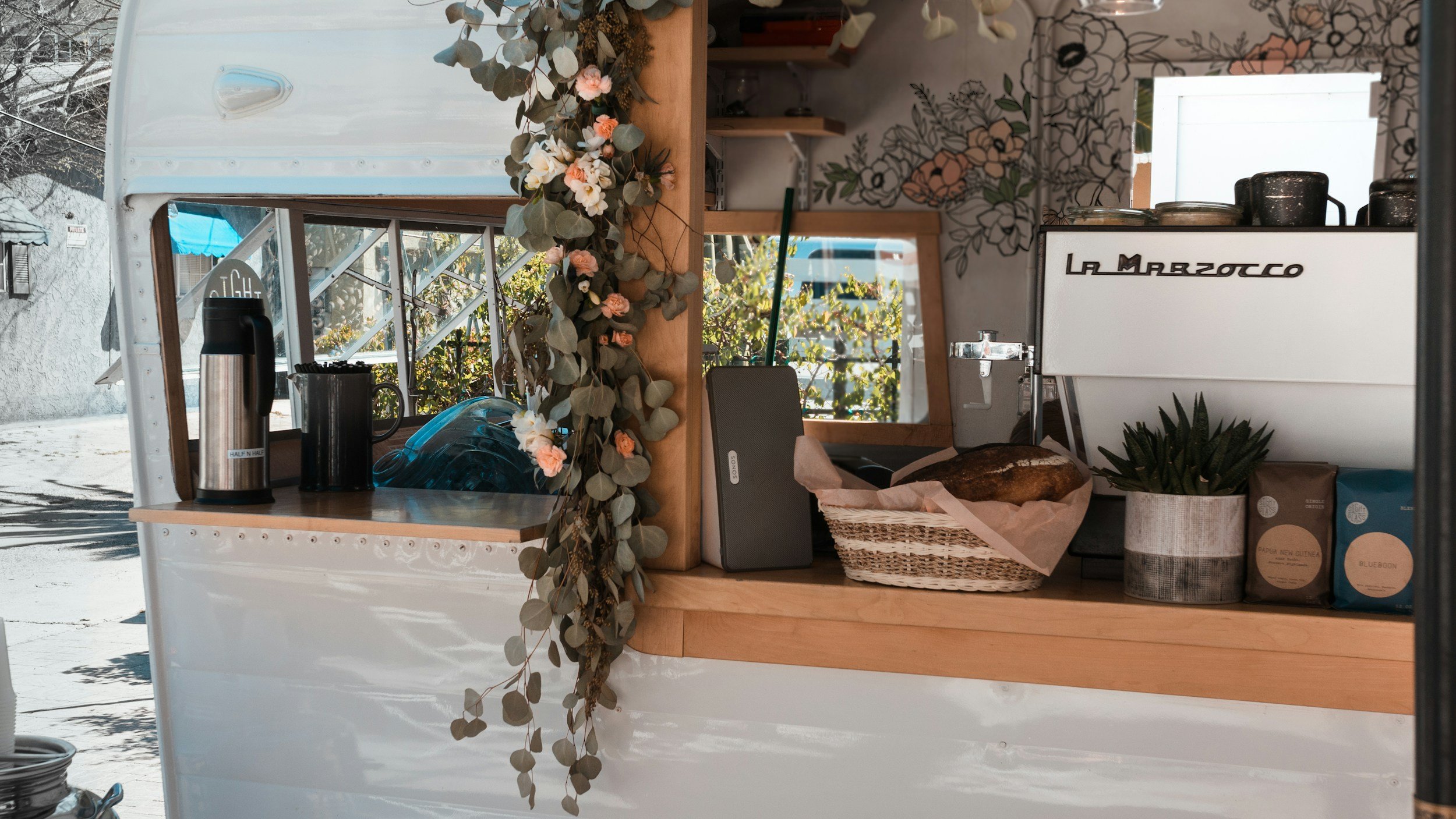 A food truck with coffee on the window