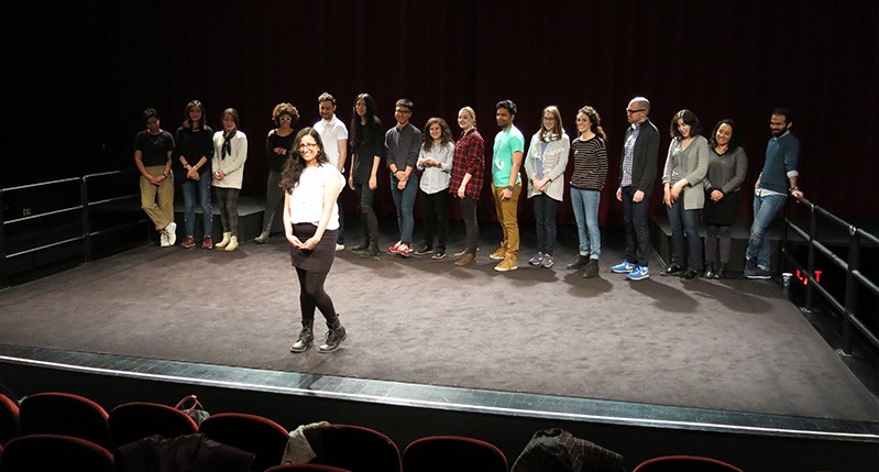 people at theater with woman in front