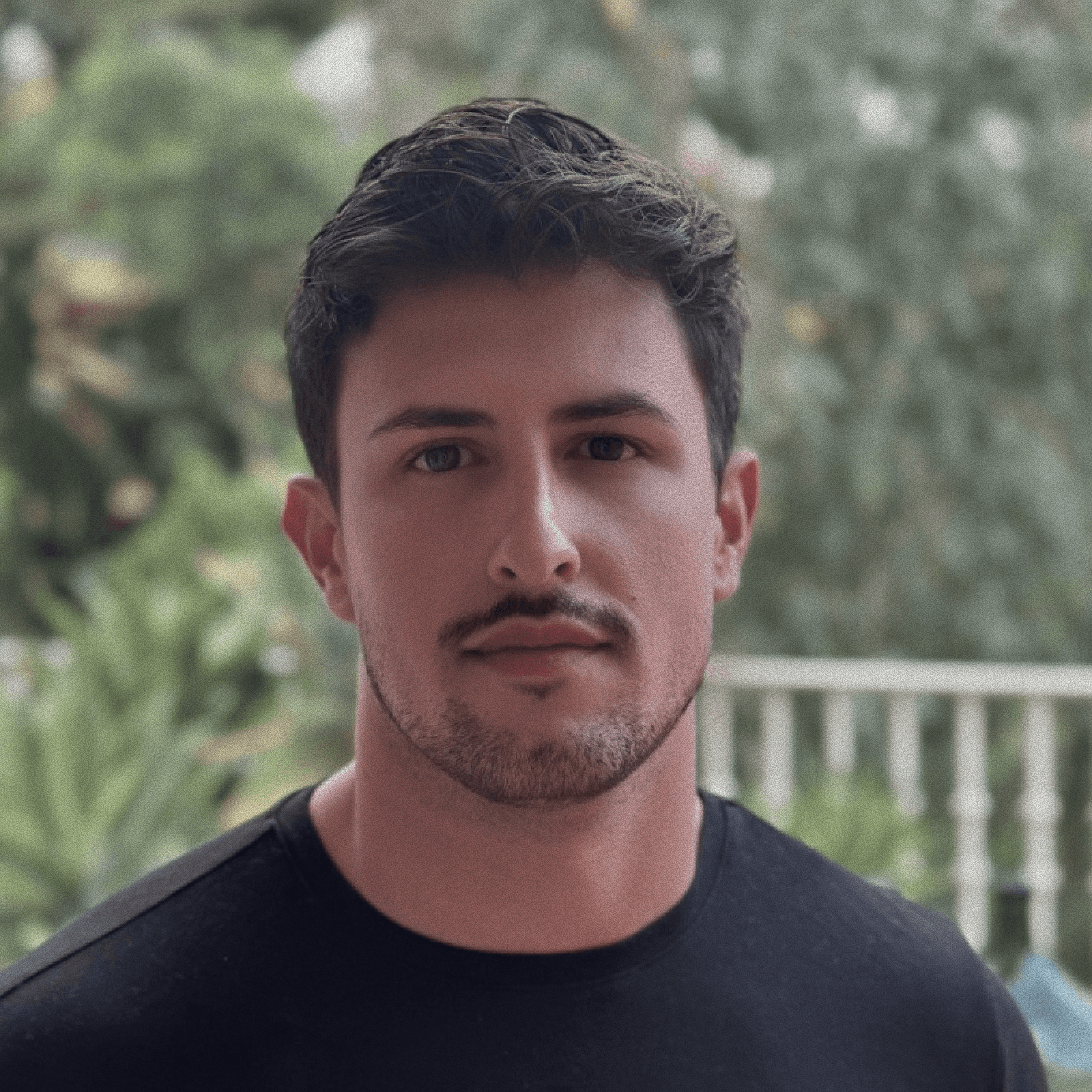 Monochrome product shot: black-capped cosmetic bottle with dynamic water splash on a clean white background.