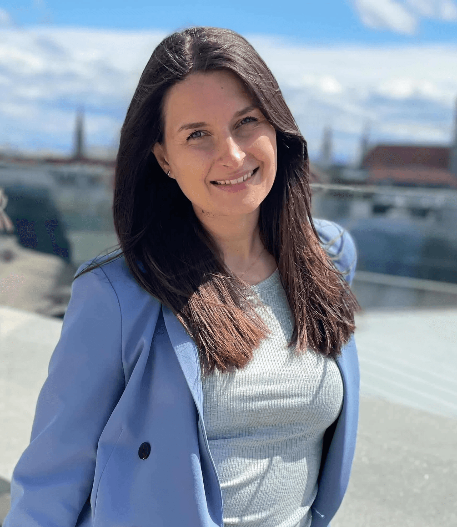 Smiling man with a blue shirt on a white background.