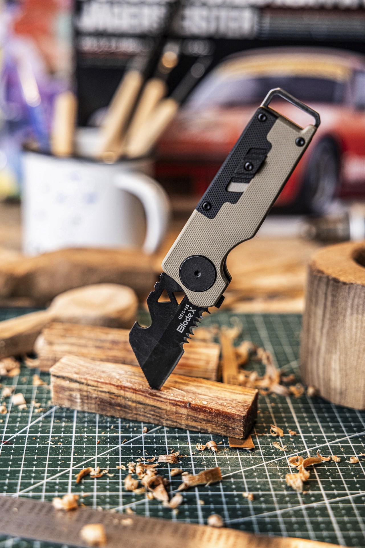 Person holding the folded BladeX GEN-195 multitool knife with tan handle, showing compact EDC form.