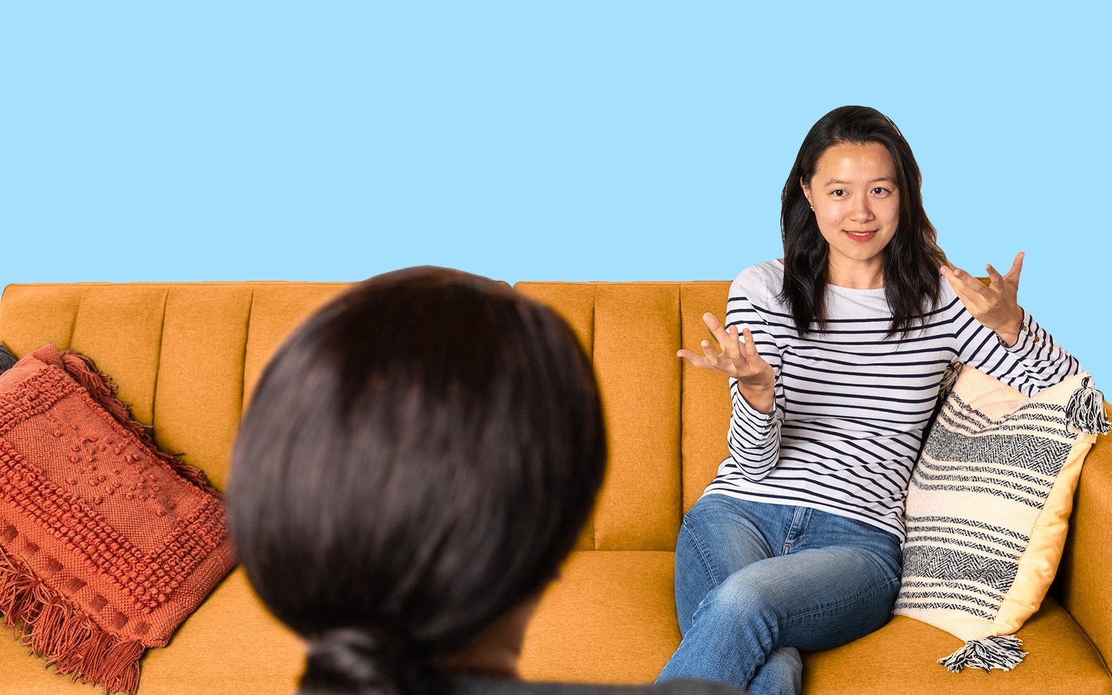 Therapist talking to client on a cozy couch