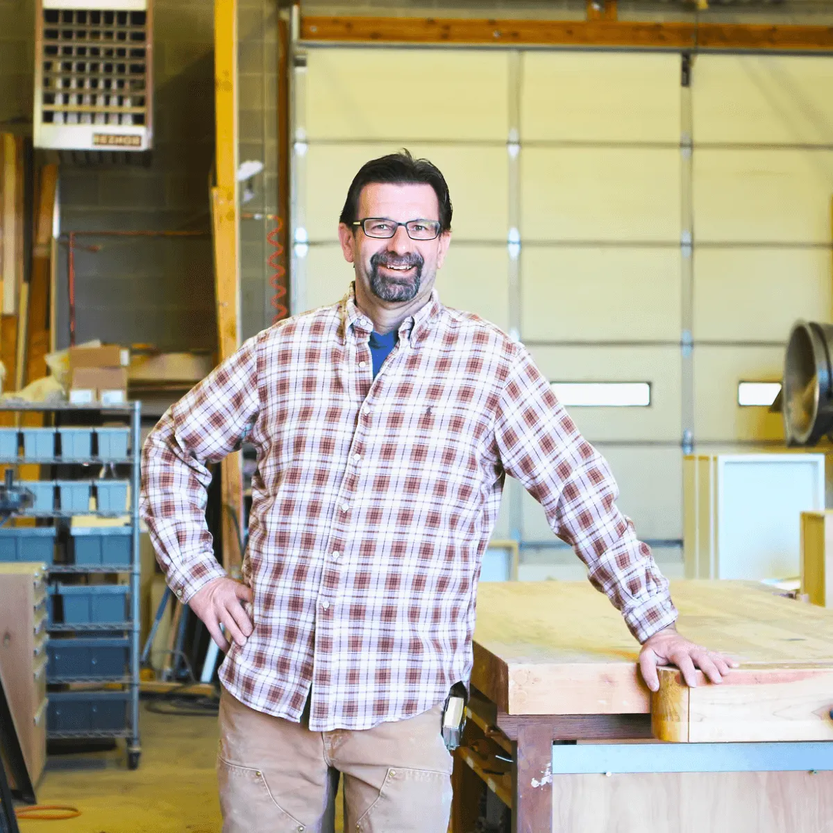 Two people sit across a table in a stylish room with red velvet walls and a large red pendant light. The mood is intimate and modern.