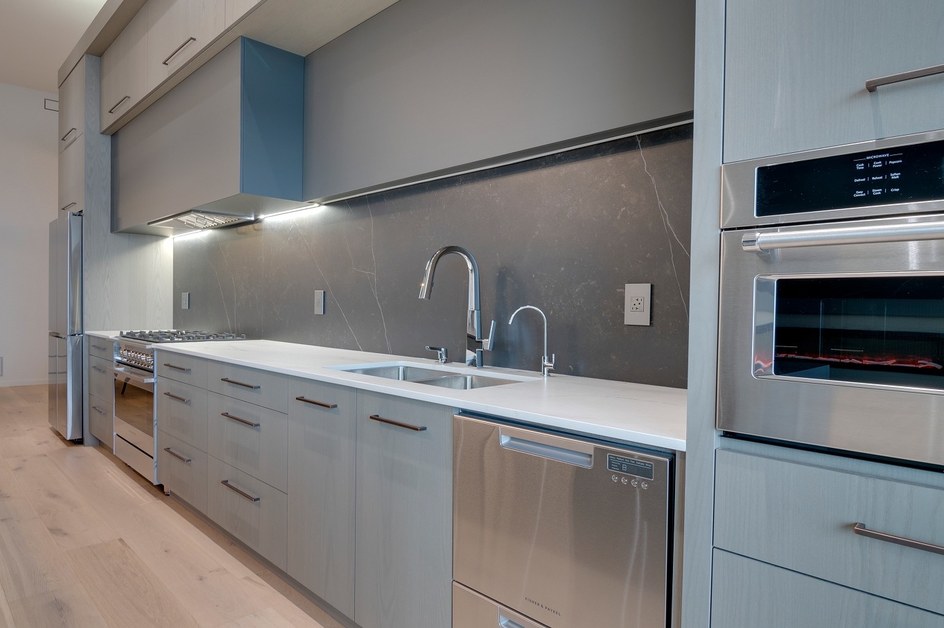 Wall of built-in kitchen appliances and custom cabinetry