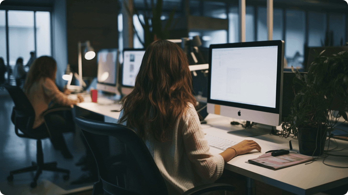 A woman sitting down working on a computer